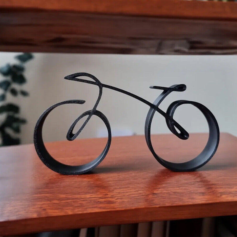 Minimalistisk cykelskulptur i metal med mat trådlook
