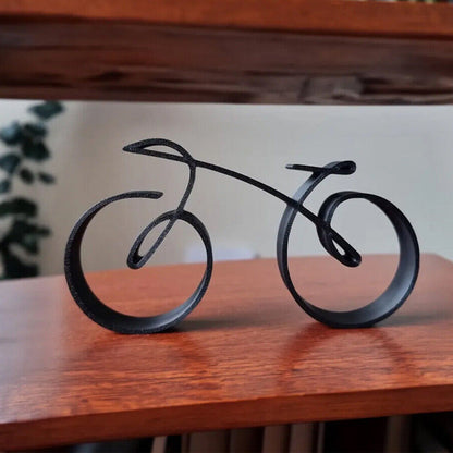 Minimalistisk cykelskulptur i metal med mat trådlook